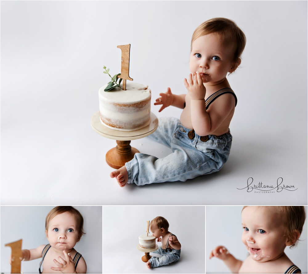 One-year-old Bennett going headfirst into his cake, mouth wide open during his cake smash session