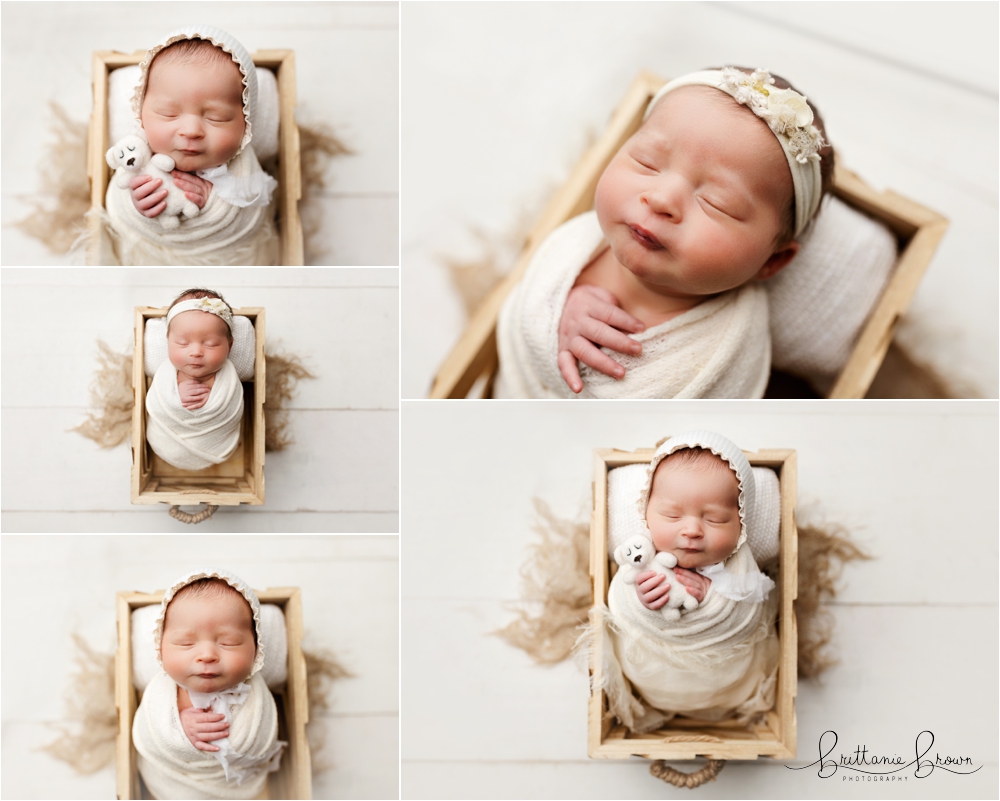 Mom holding her newborn daughter in a soft, light-filled studio.