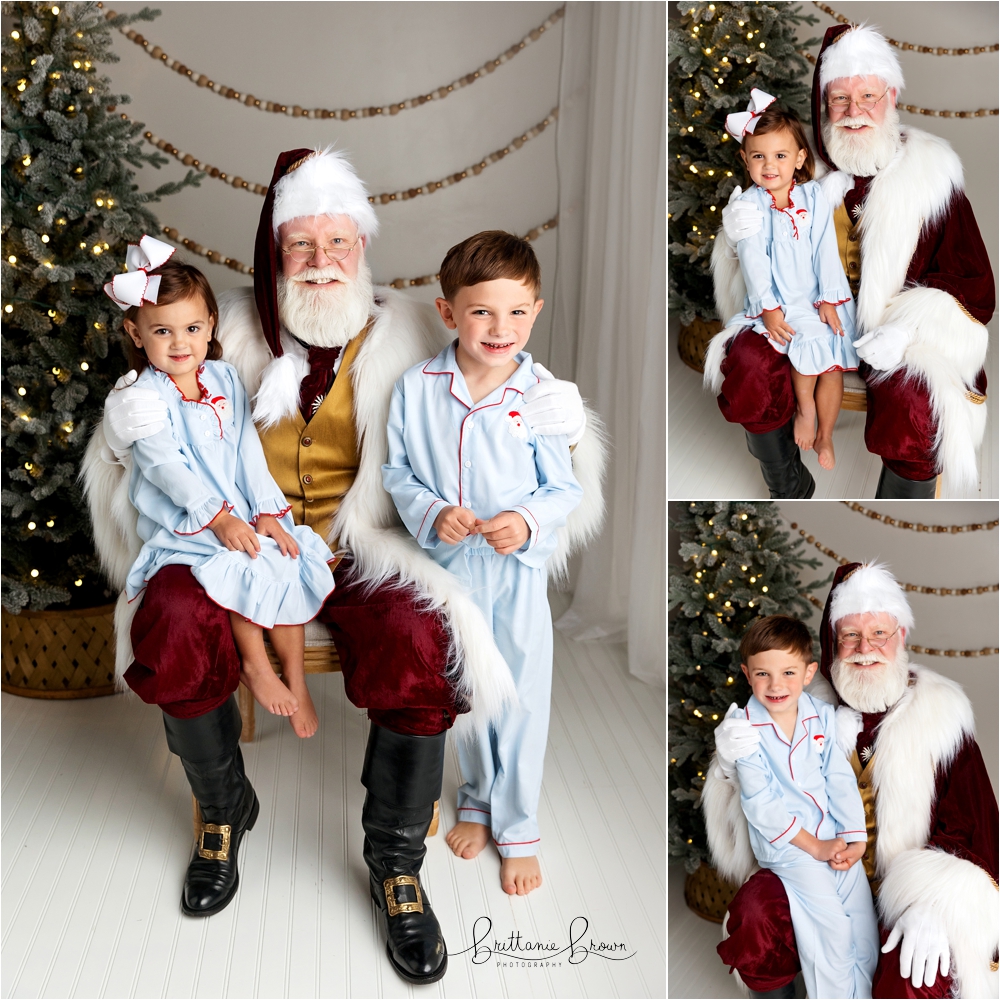 A family smiling with Santa in a holiday-themed studio.