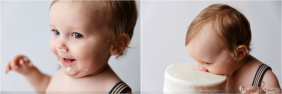 Baby face nose deep in a birthday cake.