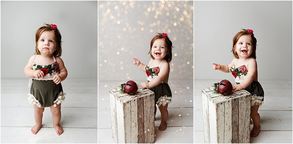 Baby Cecilia in an adorable Christmas outfit surrounded by twinkling holiday lights for her one-year milestone session.