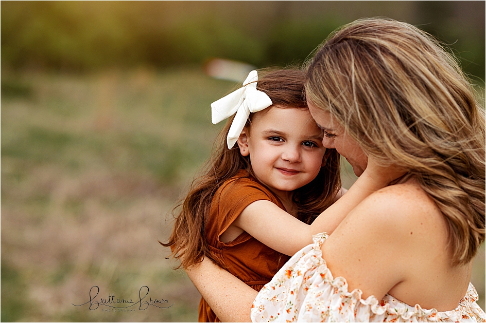 Brown eyed girl with her mom, snuggling close for an outdoor session in Georgetown, KY.
