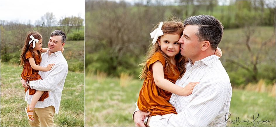 Dad holding his preschool daughter in a field during an outdoor family session in Georgetown, KY.