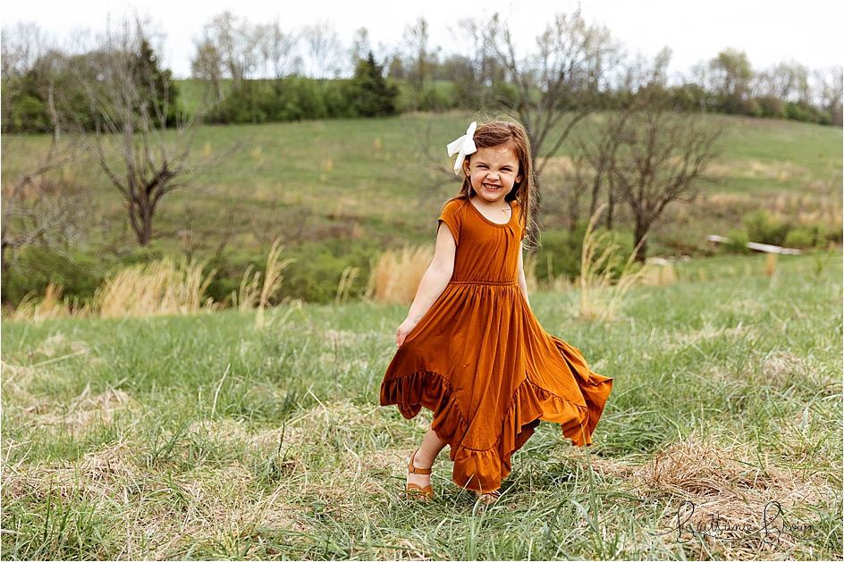 Little girl laughing during a spring photo session.