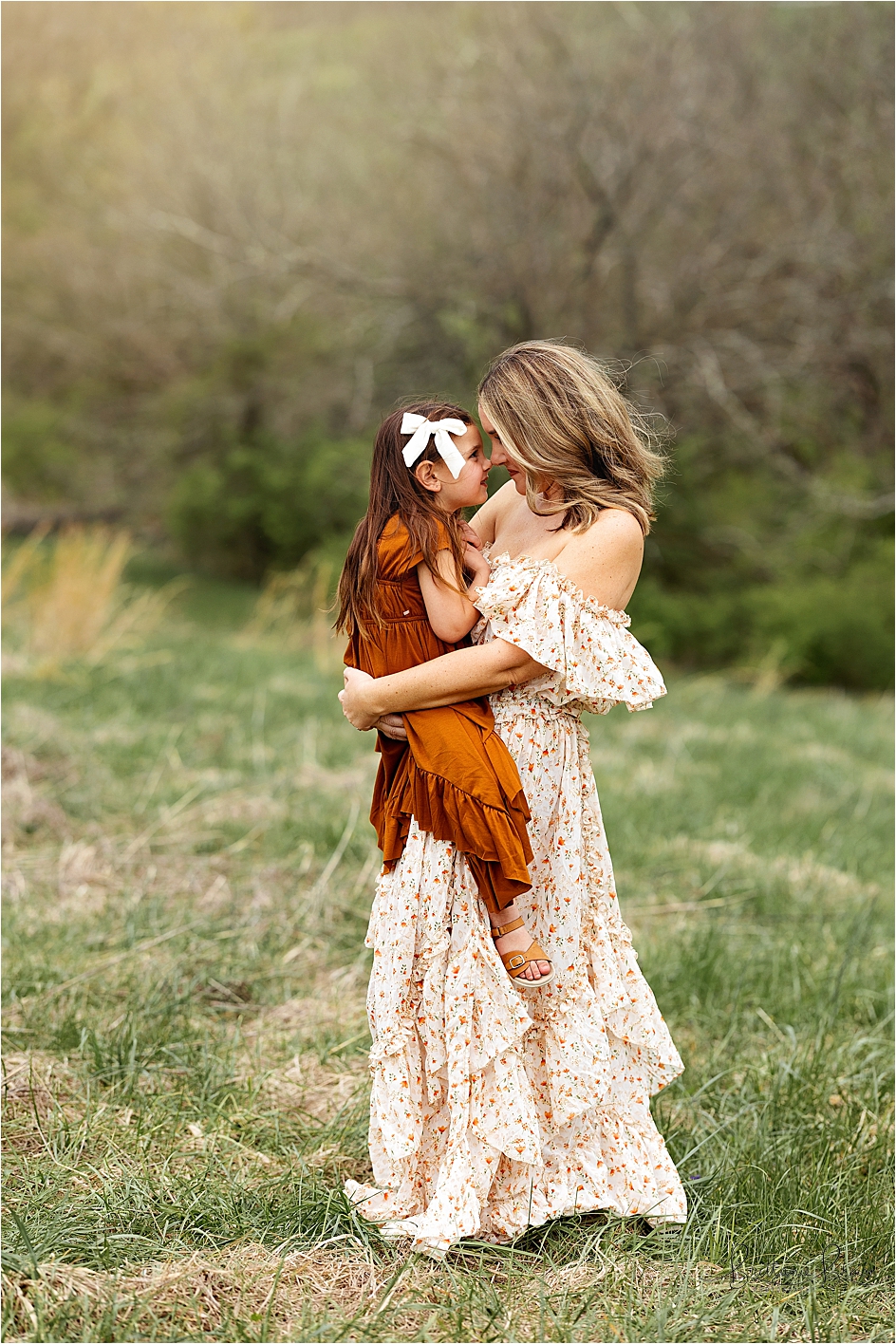 Mom and daughter snuggling outside in a field for mom and me pictures in Georgetown, KY